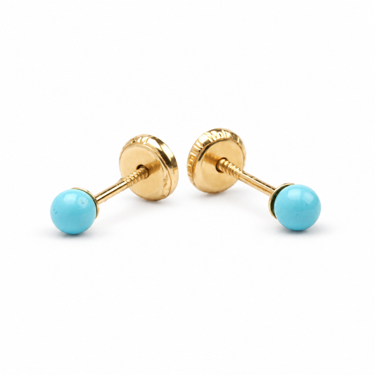 Par de aretes de bebé con turquesas en oro amarillo de 14Kt.