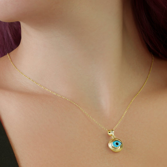 GIOVE MIO: Protection and style with our 18kt yellow gold evil eye pendant. Attract good energy and shine bright with this unique spiritual accessory! Make it yours today!