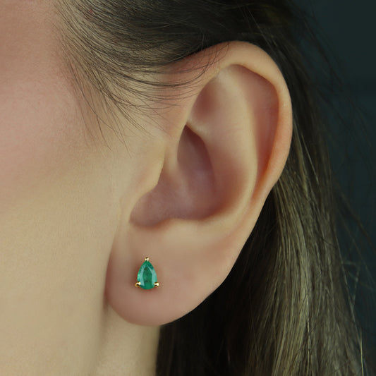 GIOVE MIO: Exclusive 14kt Yellow Gold Emerald Earrings - Enhance your style with these elegant pear-cut Emerald studs! Featuring a butterfly clasp and 2 Pear Emeralds totaling 0.70 CTW. Dare to shine with class!