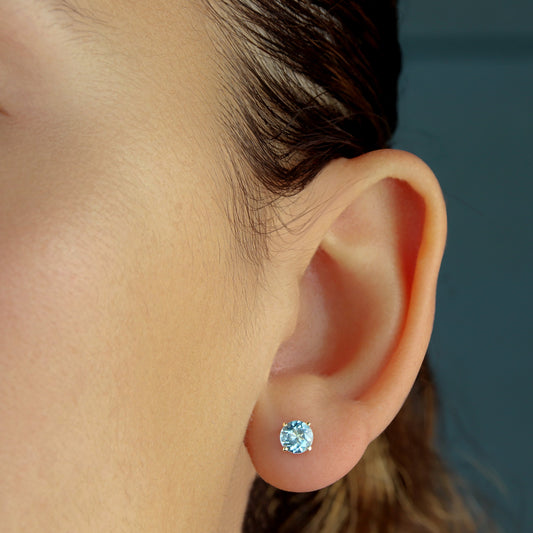 GIOVE MIO Exclusive 14kt Yellow Gold Stud Earrings with 1.21ct Sky Blue Topaz and Butterfly Backs. Illuminate your style with these radiant studs!