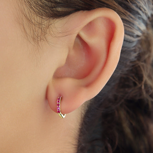 GIOVE MIO Exclusive 14kt Yellow Gold Ruby 0.24ct Huggies. Elegant and radiant earrings featuring 12 round rubies. Elevate your look with sophistication and style!